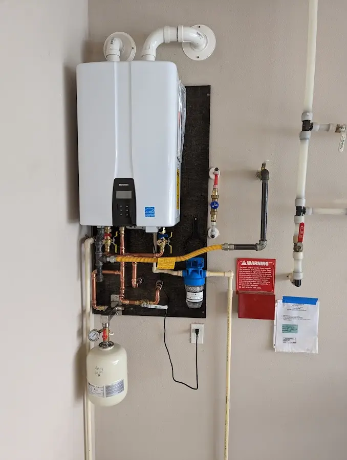 Professional plumber installing copper piping in a Woodbridge home